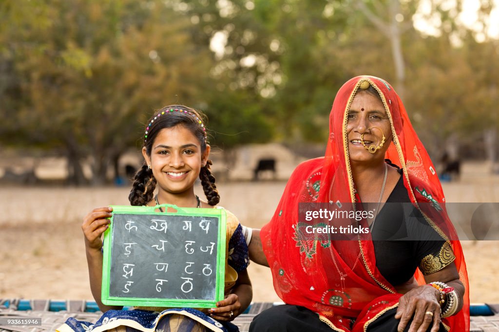 Mother with daughter holding slate