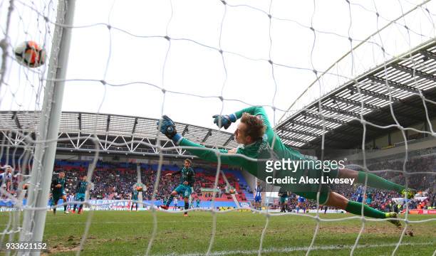 Christian Walton of Wigan Athletic saves a penalty from Manolo Gabbiadini of Southamptonduring The Emirates FA Cup Quarter Final match between Wigan...