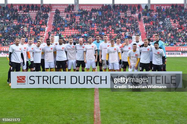 Players of Ingolstadt and Dresden pose with a sign for the campaign Strich durch Vorurteile prior to the Second Bundesliga match between FC...