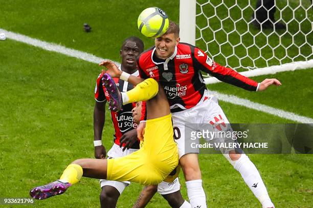 Nice's French defender Malang Sarr, Paris Saint-Germain's French defender Presnel Kimpembe and Nice's French defender Maxime Le Marchand vie for the...