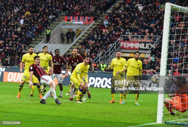 Milan's Portuguese forward Andre Silva kicks and scores during the Italian Serie A football match AC Milan vs AC Chievo at the San Siro stadium in...