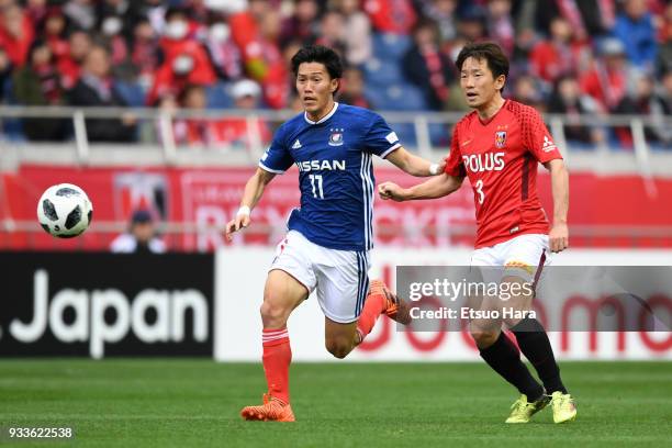 Keita Endo of Yokohama F.Marinos and Tomoya Ugajin of Urawa Red Diamonds compete for the ball during the J.League J1 match between Urawa Red Diamonds...