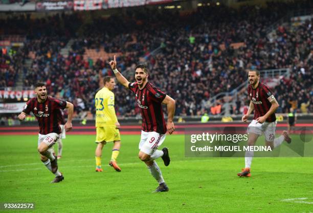 Milan's Portuguese forward Andre Silva celebrates after scoring during the Italian Serie A football match AC Milan vs AC Chievo at the San Siro...