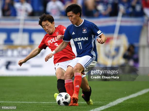 Keita Endo of Yokohama F.Marinos and Tomoya Ugajin of Urawa Red Diamonds compete for the ball during the J.League J1 match between Urawa Red Diamonds...