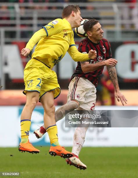 Lucas Biglia of AC Milan competes for the ball with Valter Birsa of AC Chievo Verona during the serie A match between AC Milan and AC Chievo Verona...