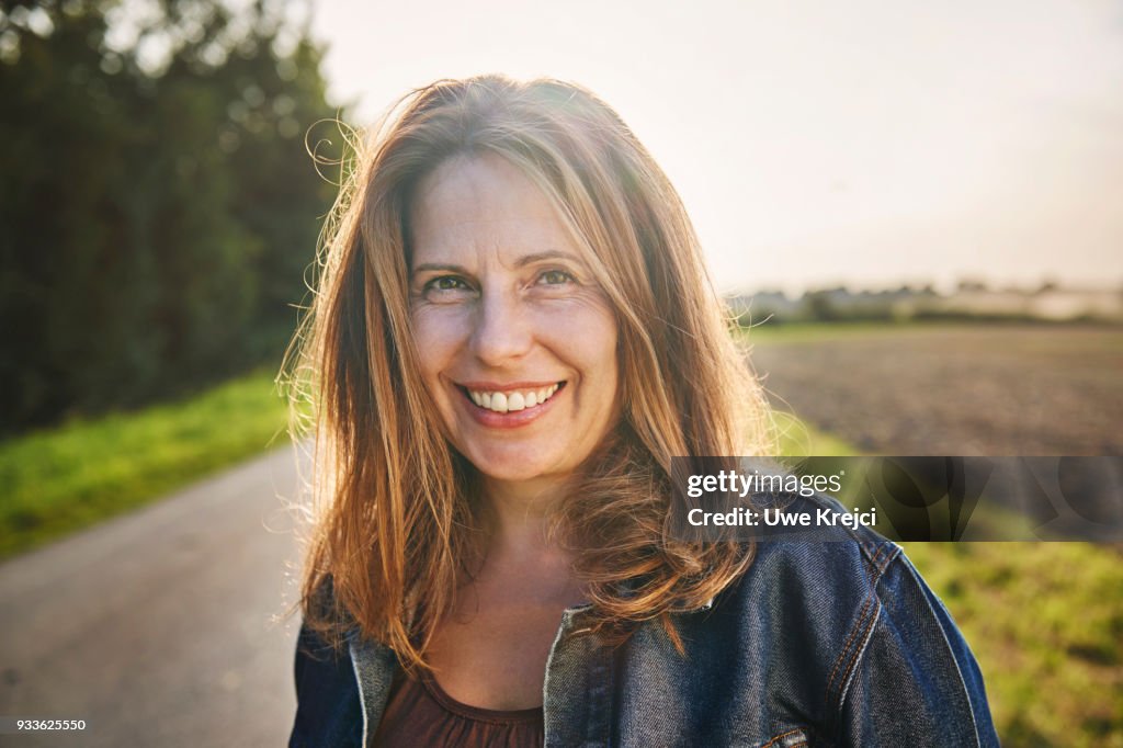 Portrait of smiling woman in the countryside