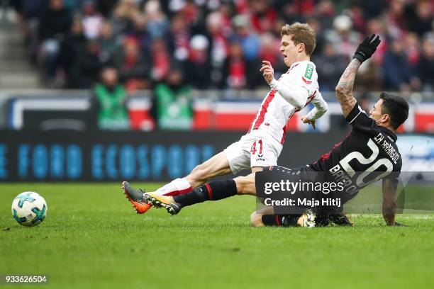 Charles Aranguiz of Bayer Leverkusen and Vincent Koziello of 1.FC Koeln battle for the ball during the Bundesliga match between 1. FC Koeln and Bayer...