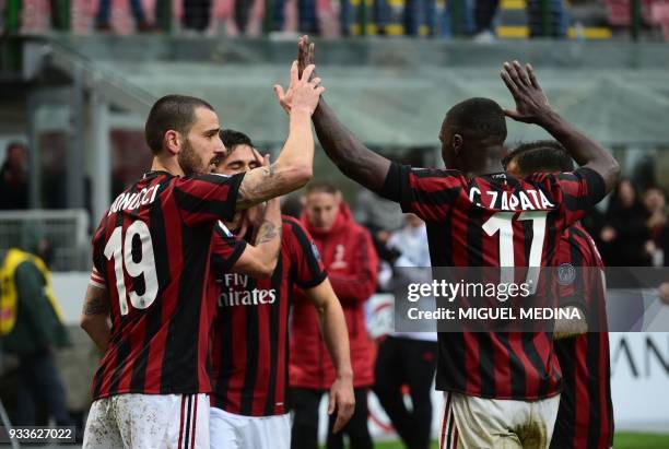 Milan's Portuguese forward Andre Silva is congratulated by AC Milan's Captain Italian defender Leonardo Bonucci , AC Milan's Colombian defender...