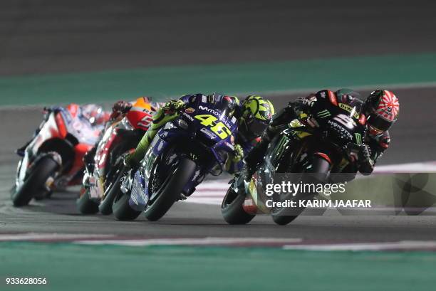 Monster Yamaha Tech 3's French rider Johann Zarco leads the pack ahead of Movistar Yamaha MotoGP's Italian rider Valentino Rossi during the 2018...