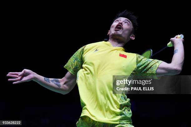 China's Lin Dan returns against China's Shi Yuqi in the men's singles final at the All England Open Badminton Championships in Birmingham, central...