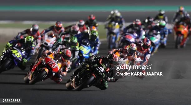 Monster Yamaha Tech 3's French rider Johann Zarco leads the pack during the 2018 Qatar Moto GP Grand Prix at the Losail International Circuit in...