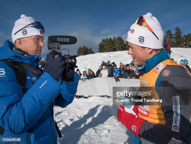 Johannes Hoesflot Klaebo of Norway give victory interview to his father Haakon Klaebo after FIS WC Men 15.0 km Pursuit Free at Lugnet Stadium on...