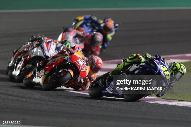 Movistar Yamaha MotoGP's Italian rider Valentino Rossi rides his Yamaha ahead of Repsol Honda Team's Spanish rider Marc Marquez during the 2018 Qatar...