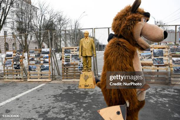 Activists and supporters of different Ukrainian nationalist parties perform with figure depicting Russian President Vladimir Putin during their...