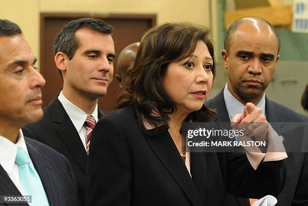 The US Secretary of Labor Hilda Solis briefs the media next to White House Office of Urban Affairs Director Adolfo Carrion and Los Angeles Mayor...