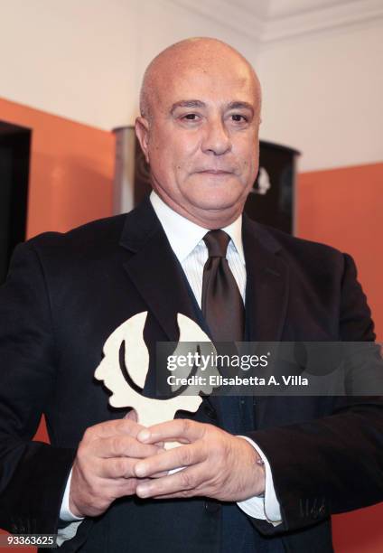 Stefano Dominella, fashion house Gattinoni's president, shows his award during the '2009 Margutta Awards' at Margutta RistoArte on November 24, 2009...