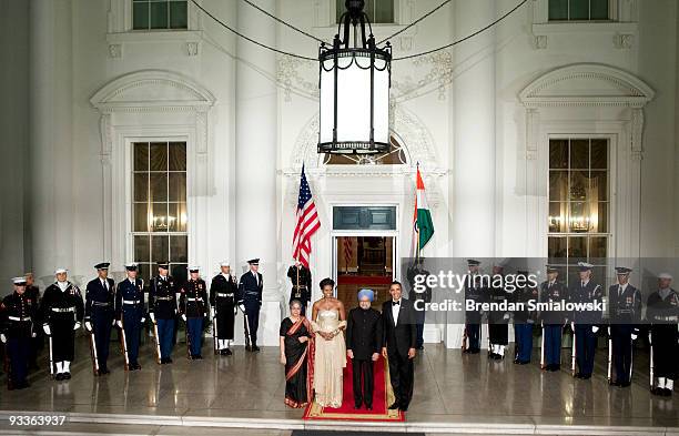 Prime Minister of India Manmohan Singh and his wife Gursharan Kaur stand with U.S. President Barack Obama and first lady Michelle Obama before a...