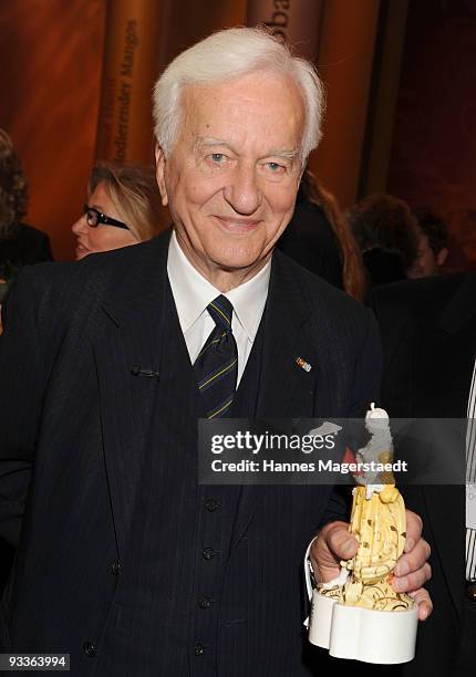 Richard Freiherr von Weizsaecker shows his award during the annual Corine awards at the Prinzregenten Theatre on November 24, 2009 in Munich,...