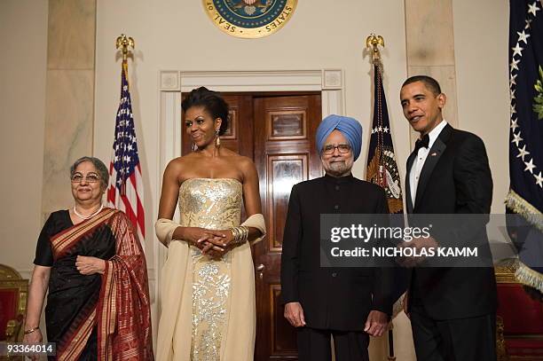 President Barack Obama and First Lady Michelle Obama pose for photos with Indian President Manmohan Singh and his wife Gursharan Kaur in Cross Hall...