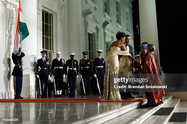 President Barack Obama and first lady Michelle Obama greet Prime Minister of India Manmohan Singh and his wife Gursharan Kaur in the North Portico of...