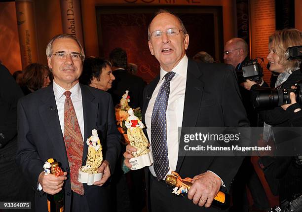 Nicholas Stern and Alex S. MacLean hold their awards during the annual Corine awards at the Prinzregenten Theatre on November 24, 2009 in Munich,...