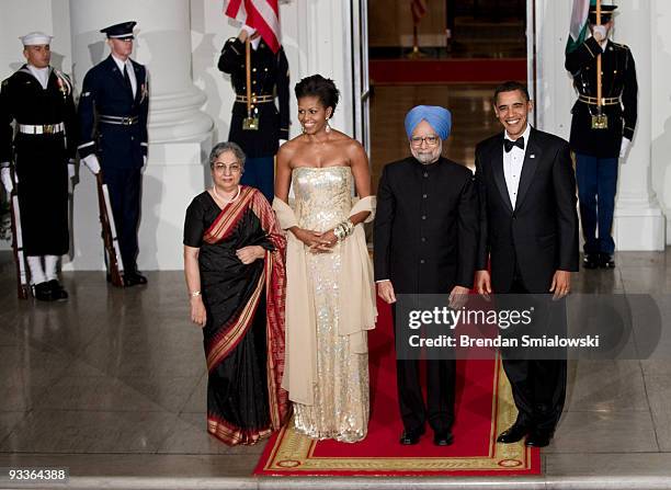 Prime Minister of India Manmohan Singh and his wife Gursharan Kaur stand with President Barack Obama and first lady Michelle Obama before a state...