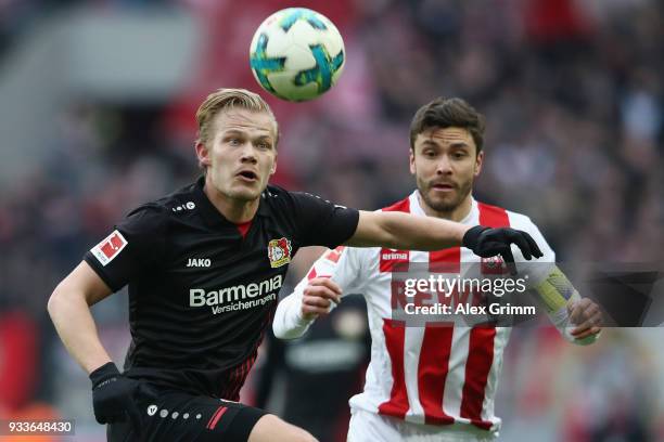 Joel Pohjanpalo of Leverkusen is challenged by Jonas Hector of Koeln during the Bundesliga match between 1. FC Koeln and Bayer 04 Leverkusen at...