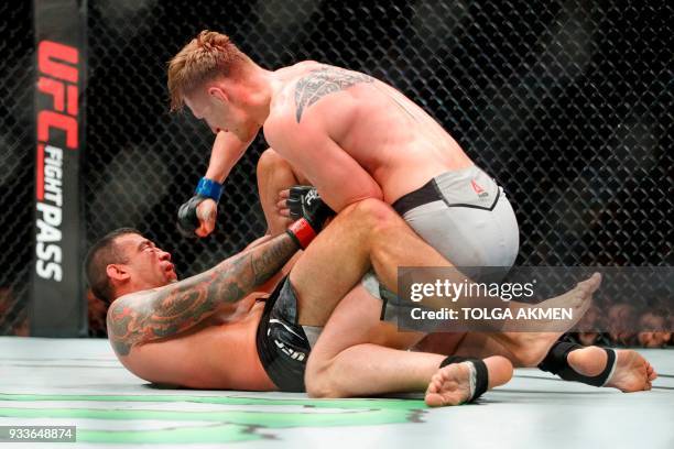 Russia's Alexander Volkov punches Brazil's Fabrico Werdum in their Heavyweight fight during the UFC Fight Night at the O2 Arena in London on March...