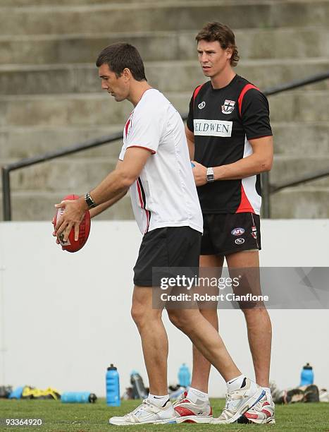 Saints assistant coach Stephen Silvagni lines up a kick as Justin Koschitzke of the Saints looks on during a St Kilda Saints AFL training session...