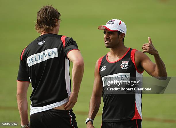 Andrew Lovett of the Saints talks to teammate Justin Koschitzke during a St Kilda Saints AFL training session held at Linen House Oval on November...