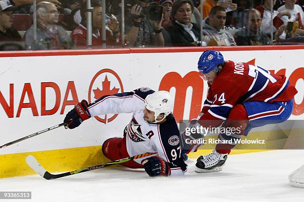 Sergei Kostitsyn of the Montreal Canadiens trips Rostislav Klesla of the Columbus Blue Jackets during the NHL game on November 24, 2009 at the Bell...