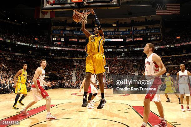 Roy Hibbert of the Indiana Pacers slam dunks in front of Hedo Turkoglu and Rasho Nesterovic of the Toronto Raptors during a game on November 24, 2009...