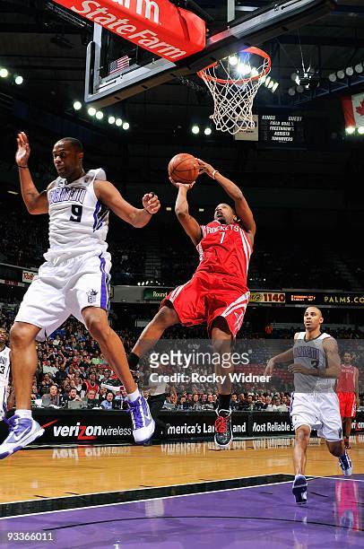 Kyle Lowry of the Houston Rockets puts up a shot between Kenny Thomas and Ime Udoka of the Sacramento Kings during the game on November 13, 2009 at...