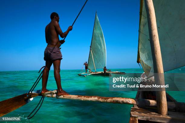 tanzania, zanzibar, fisher on local boat at jambiani - indian ocean stock pictures, royalty-free photos & images