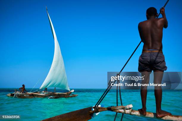 tanzania, zanzibar,  fisher on local boat at jambiani - fisherman foto e immagini stock