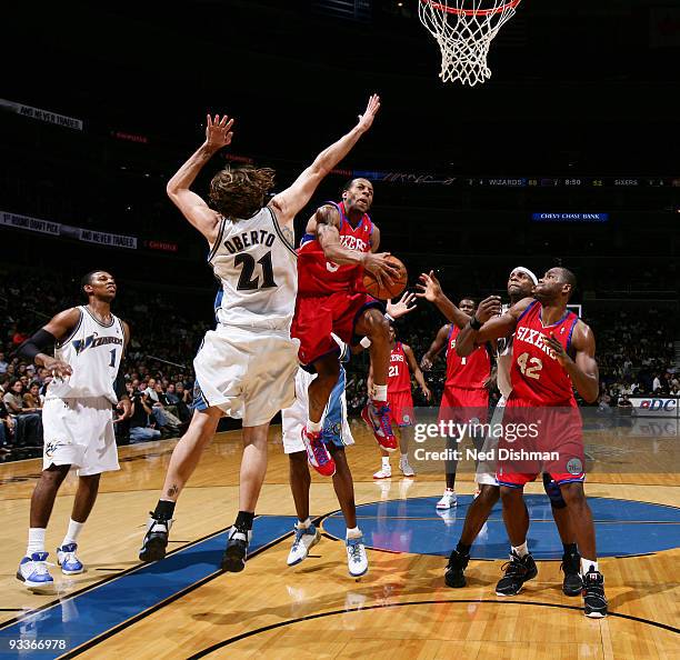 Andre Iguodala of the Philadelphia 76ers shoots against Fabricio Oberto of the Washington Wizards at the Verizon Center during the game on November...