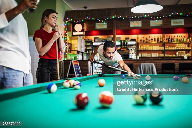 stylish young friends playing pool together - bar berlin stock pictures, royalty-free photos & images