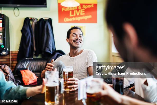 group of friends drinking together at a pool hall - kneipe stock-fotos und bilder