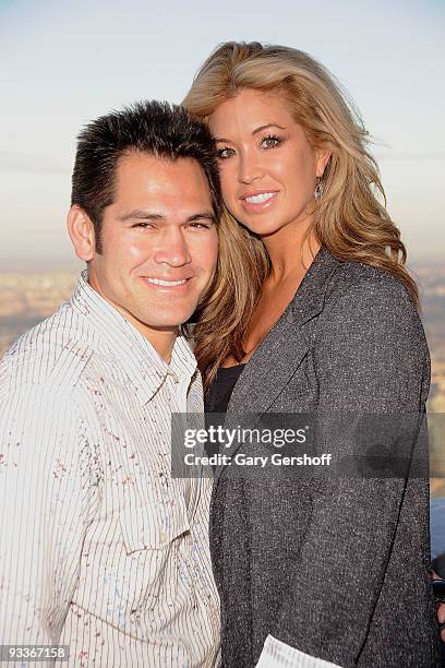 New York Yankee Johnny Damon , and wife Michelle Mangan-Damon pose for pictures on the uppermost level of The Empire State Building in celebration of...