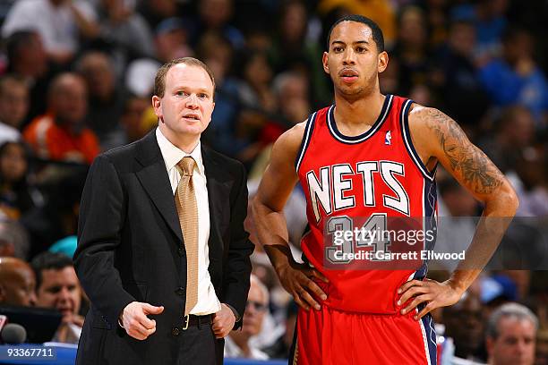 Head coach Lawrence Frank of the New Jersey Nets talks with Devin Harris of the New Jersey Nets against the Denver Nuggets on November 24, 2009 at...