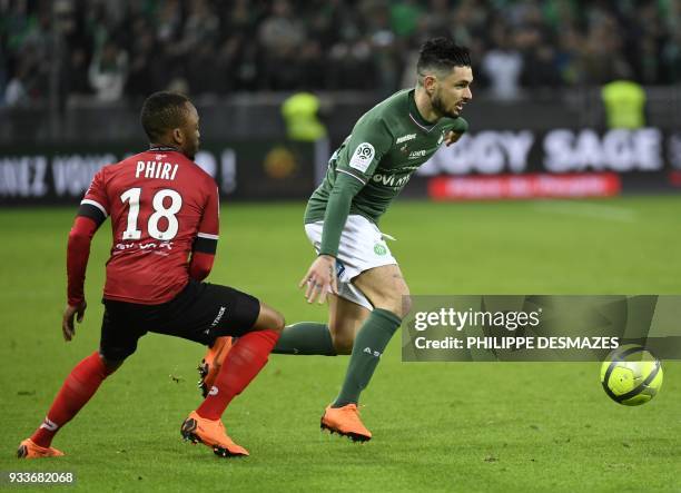 Saint-Etienne's French forward Remy Cabella vies with Guingamp's South african midfielder Lebogang Phiri during the French L1 football match between...