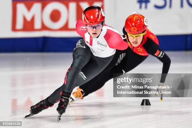 Kim Boutin of Canada skates ahead of Jinyu Li of China the group in the women's 1000 meter quarterfinals during the World Short Track Speed Skating...