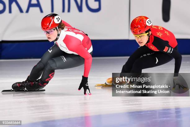 Kim Boutin of Canada skates ahead of Jinyu Li of China in the women's 1000 meter quarterfinals during the World Short Track Speed Skating...