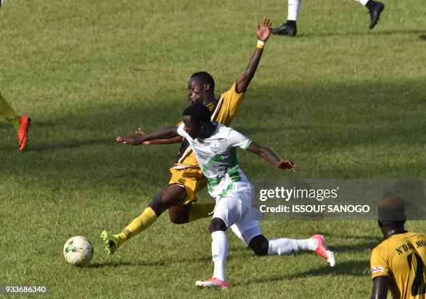 Ivory Coast's Anicet Badie Gbagnon vies with Zambia's Lazzrous Kambole during the Confederation of African Football Champions League match between...