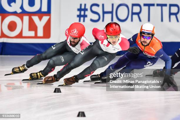 Charles Hamelin of Canada , Samuel Girard of Canada and Sjinkie Knegt of the Netherlands compete in the men's 1000 meter quarterfinals during the...