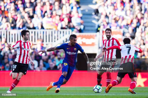 Paulinho of FC Barcelona conducts the ball among Markel Susaeta, Raul Garcia and Benat Etxebarria of Athletic Club during the La Liga match between...