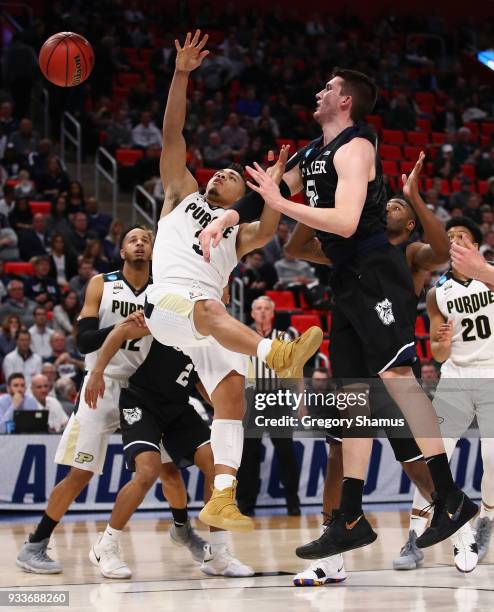 Nate Fowler of the Butler Bulldogs defends a shot by Carsen Edwards of the Purdue Boilermakers during the first half in the second round of the 2018...