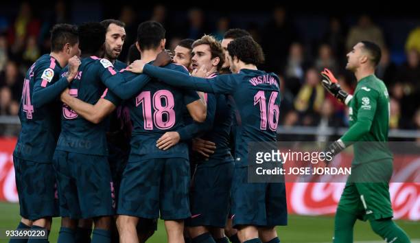 Atletico Madrid's French forward Antoine Griezmann celebrates a goal with teammates during the Spanish League football match between Villarreal CF...