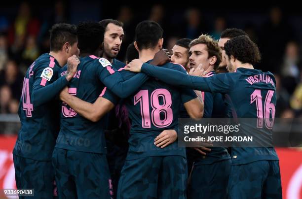 Atletico Madrid's French forward Antoine Griezmann celebrates a goal with teammates during the Spanish League football match between Villarreal CF...