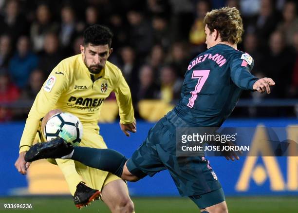 Villarreal's Spanish defender Alvaro Gonzalez vies with Atletico Madrid's French forward Antoine Griezmann during the Spanish League football match...